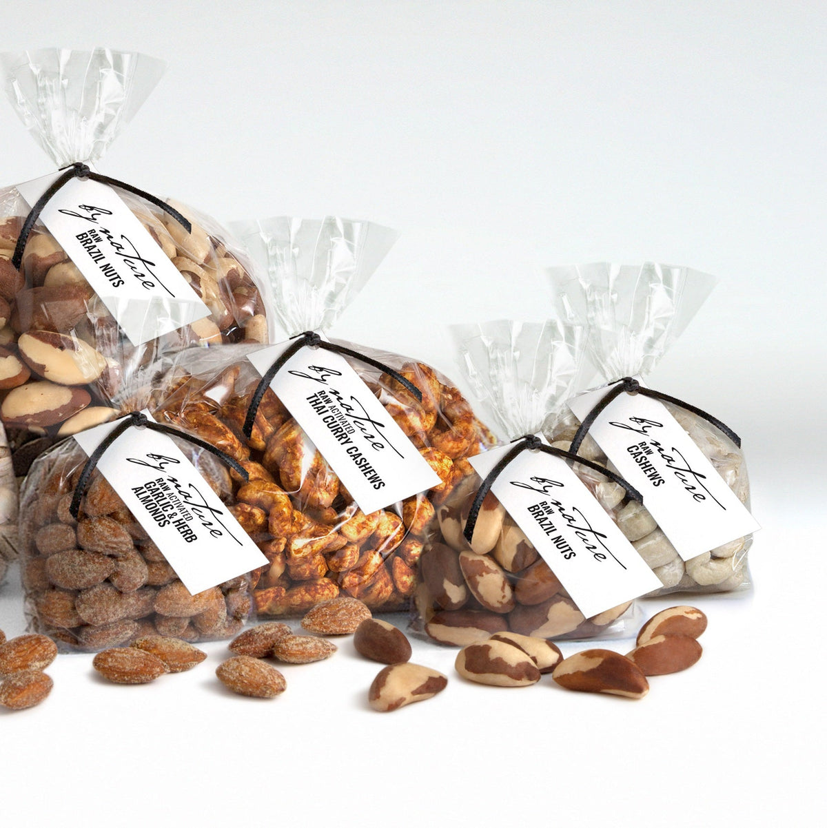 Assorted bags of roasted nuts with visible labels on a white background