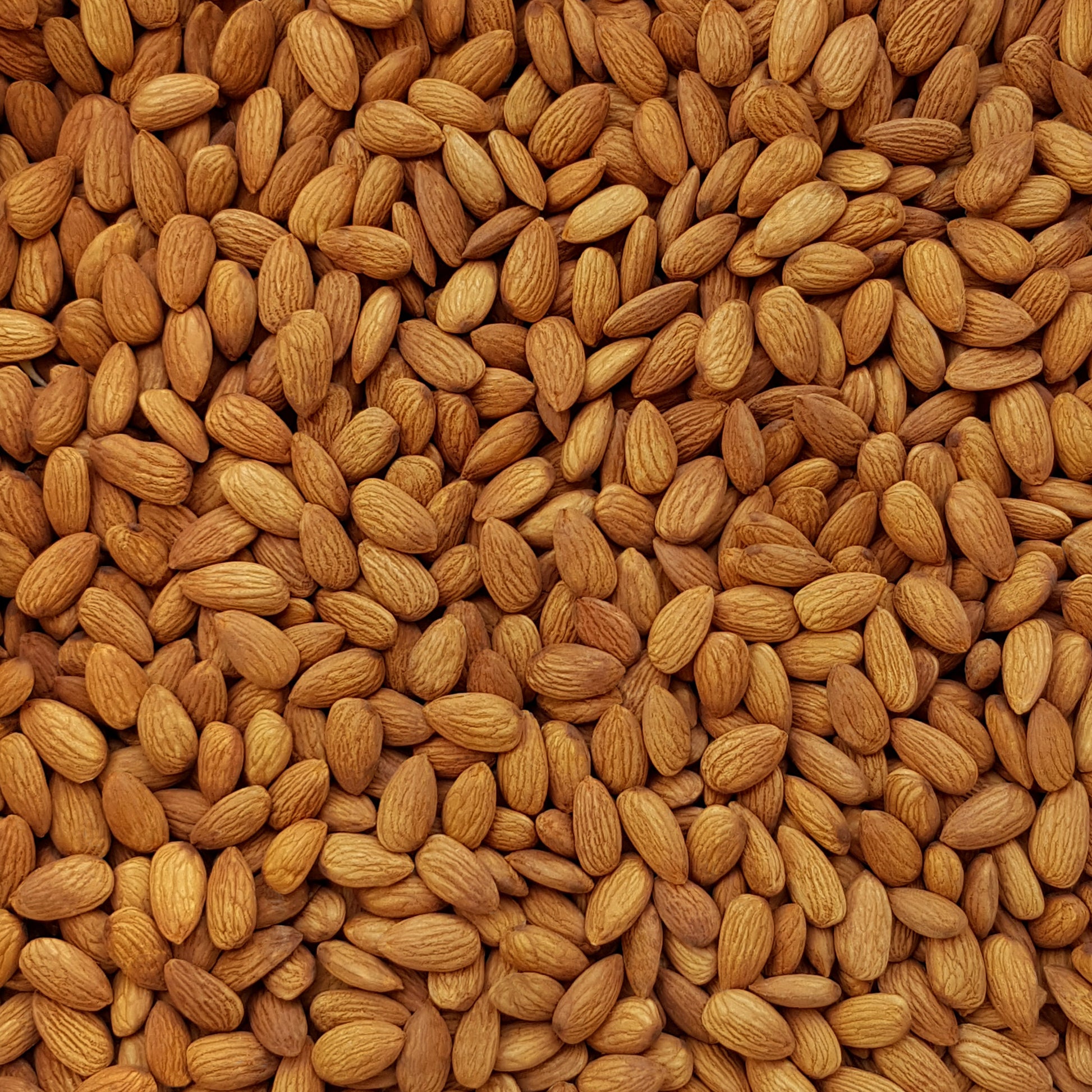 Full frame overhead image of BY NATURE Almonds - Nonpareil Supreme variety, raw, unpasteurised.