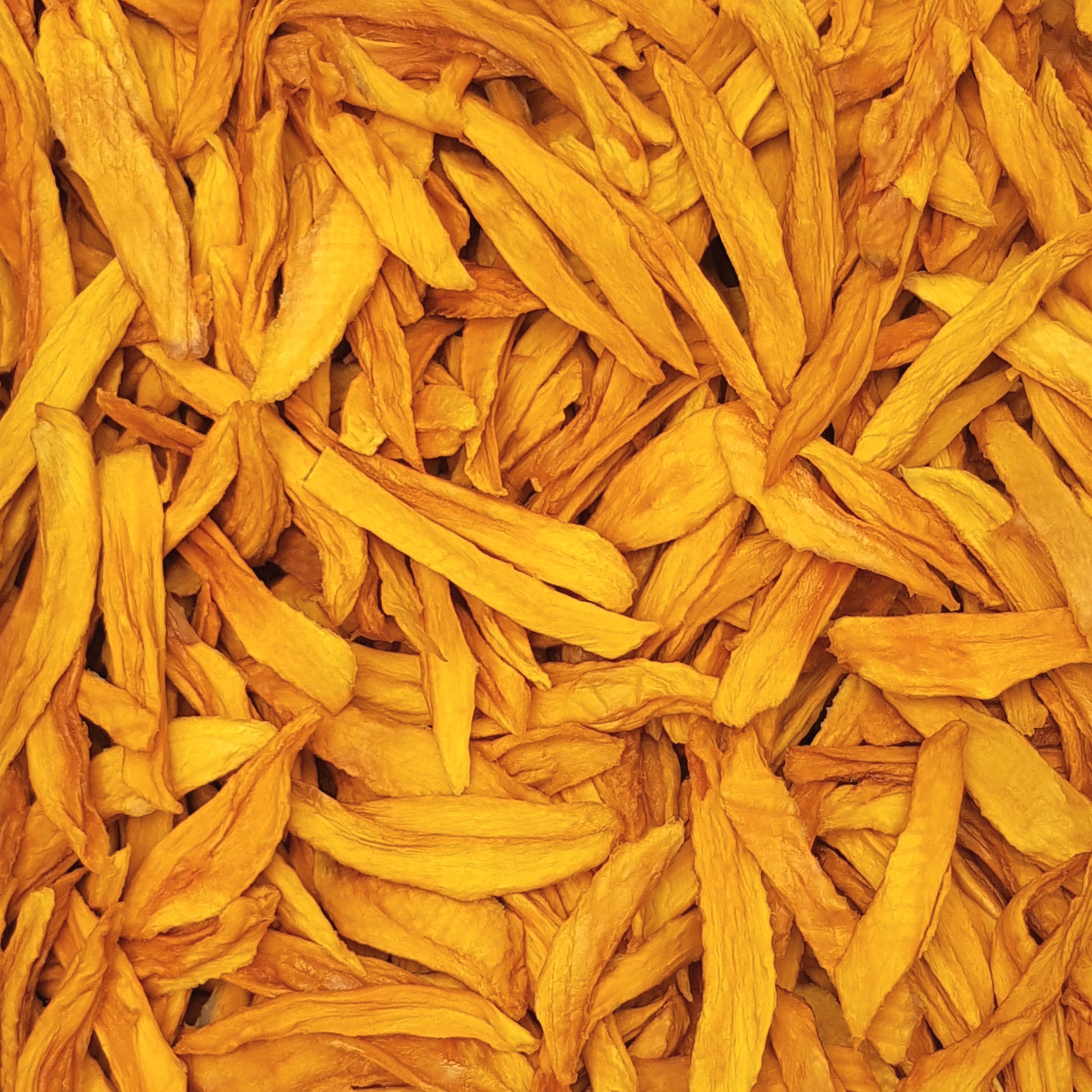 Full frame overhead image of BY NATURE Dried Mango Strips - sulphur-free.