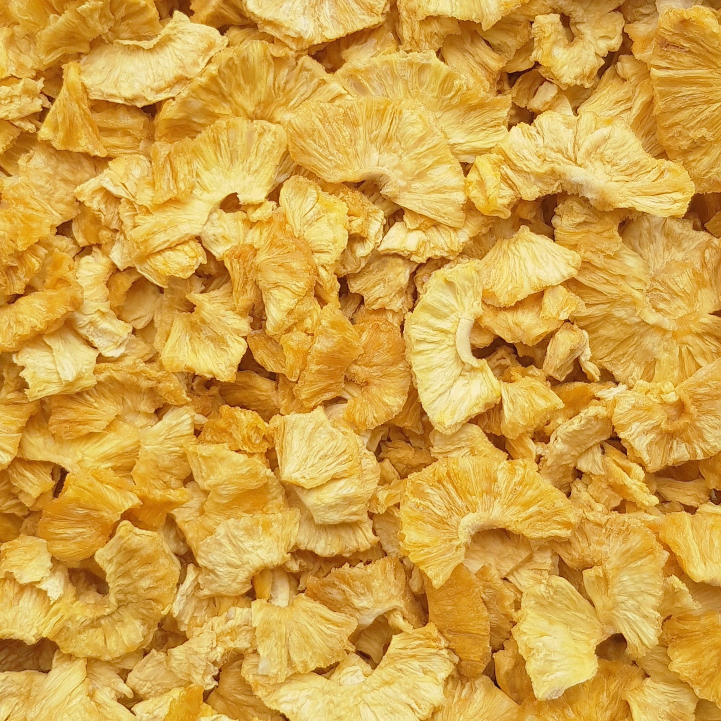 Full frame overhead image of BY NATURE Dried Pineapple Pieces - preservative-free.