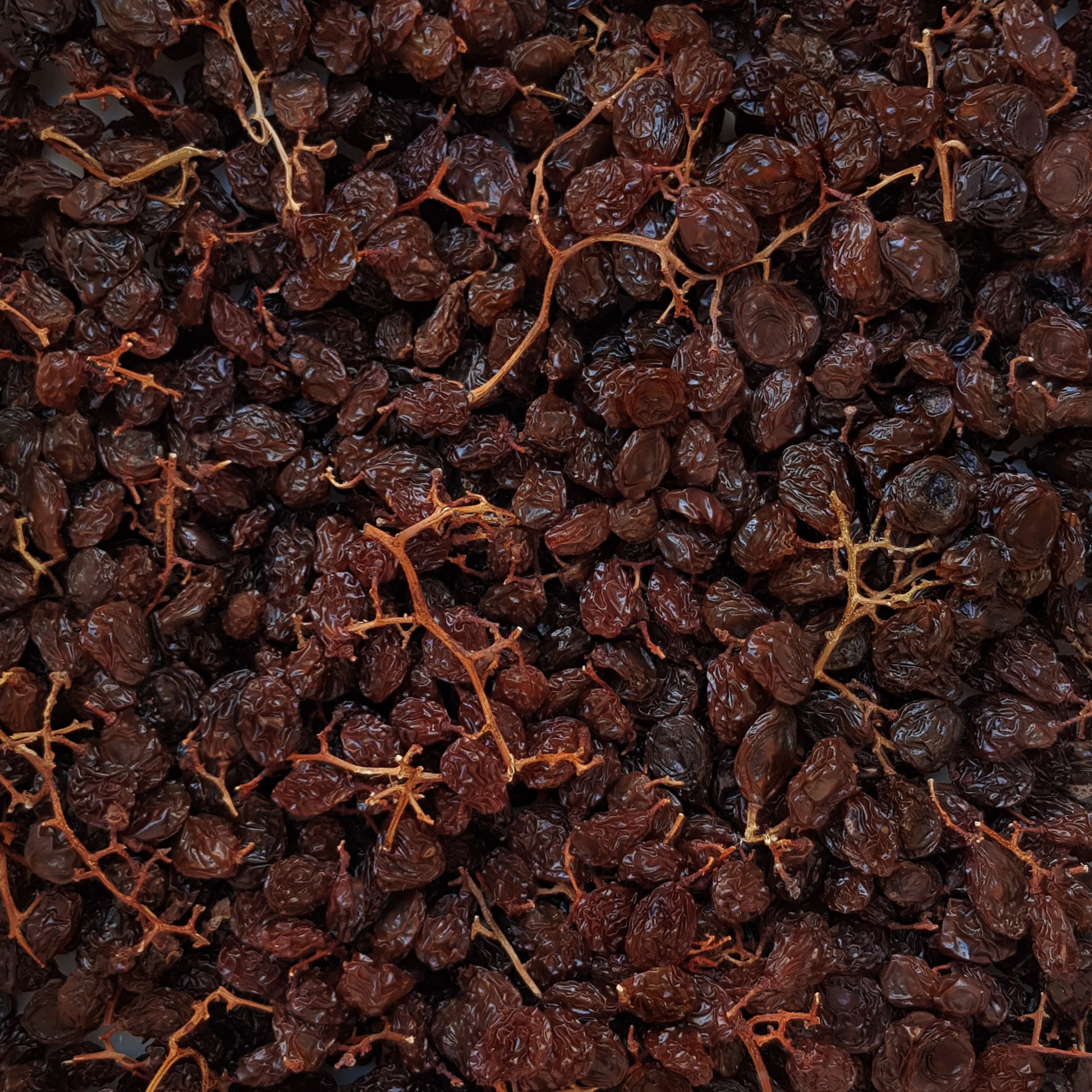 Full frame overhead image of BY NATURE Hanepoot Stalk Rainsins with seeds - preservative-free.