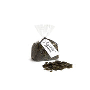 Bag of pumpkin seeds with a visible brand label on a white background